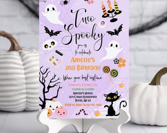 May include: A lavender Halloween-themed invitation with the text "Two Spooky" and "Amelie's 2nd Birthday." The design includes ghosts, bats, pumpkins, and a black cat. The invitation is hand-drawn and includes event details.