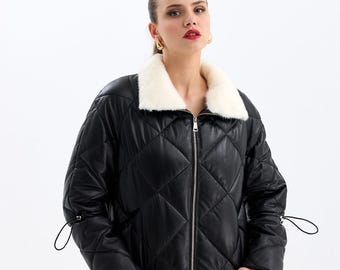 May include: A black quilted leather jacket with a white faux fur collar and drawstring closures at the cuffs.