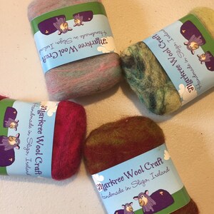 May include: Four colorful wool craft rolls. Each roll is wrapped with a label that reads "Markree Wool Craft Handmade in Sligo, Ireland." The wool colors include pink and gray, green and blue, red, and brown and green.