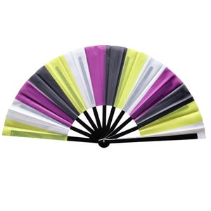 May include: A colorful folding fan with a black handle and ribs. The fan features alternating panels of white, yellow, purple, and black. The fan is open, displaying its full, semi-circular shape against a white background.