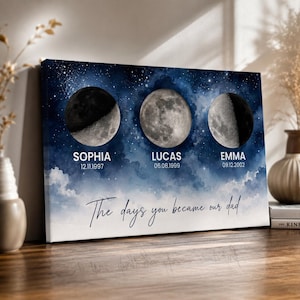 May include: A personalized canvas print featuring three moon phases against a starry night sky. Each moon phase has a name and date below it. The text "The days you became our dad" is written in cursive.