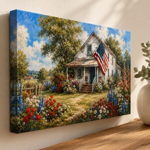 May include: A rectangular canvas wall art print depicting a white farmhouse with a porch and an American flag hanging from the roof. The scene includes a dirt path, lush green trees, and a vibrant garden filled with red, white, and blue flowers.