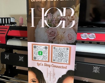 May include: A banner announcing the grand reopening of "Haus of Blossom" Aesthetics & Spa. The banner features a floral design with the text "Welcome to our GRAND REOPENING" and a QR code for customers to stay connected.