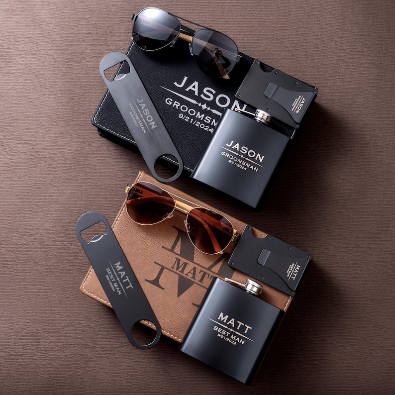 May include: A collection of personalized gifts, including sunglasses, wallets, flasks, and bottle openers. The items are arranged on a brown surface. The text on the items includes names and dates, suggesting a groomsmen or best man theme.
