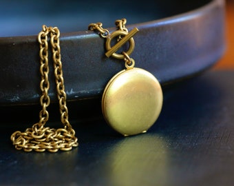 Gold Locket Necklace. Vintage brass chain and round locket with toggle clasp. Front clasp necklace. T clasp necklace. Long layering Necklace