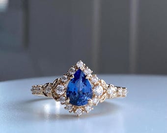 Kassandra Blue Sapphire engagement ring. Unique pear cut Fantasy gold engagement ring with sapphire and diamonds. Delicate intricate ring