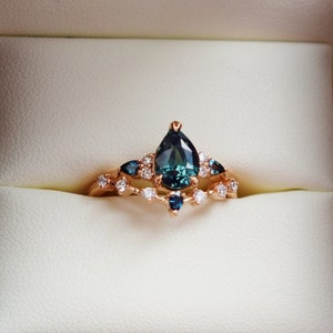 Teal Sapphire Bridal Set. Pear cut sapphire engagement ring and matching diamond band.