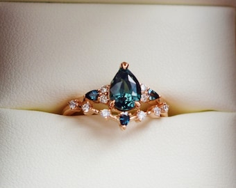 Teal Sapphire Bridal Set. Pear cut sapphire engagement ring and matching diamond band.