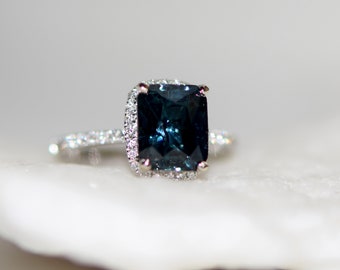 Radiant cut teal engagement ring. Deep blue green sapphire engagement ring. Rectangle engagement ring. White gold peacock sapphire rings