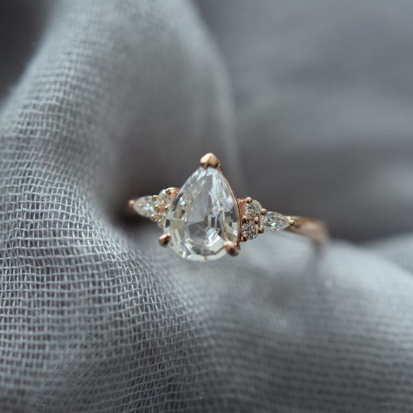 White sapphire engagement ring. Alternative engagement ring. Pear cut white sapphire and diamonds ring. Natural sapphire engagement ring