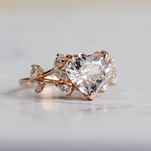 Unique pink sapphire heart shaped engagement ring. Moonlight white sapphire and diamonds. 14k rose gold ring by Eidelprecious. Ready to ship