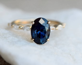 Oval Navy blue sapphire engagement ring on marquise diamond band by Eidelprecious