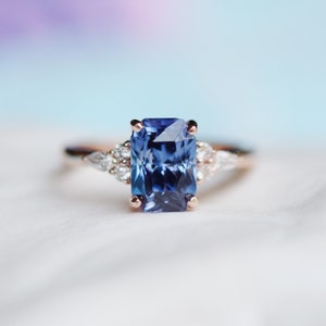 Radiant Blue Sapphire Ring in 14k gold with diamond clusters. Emerald Radiant cut Sapphire ring. Campari by Eidelprecious