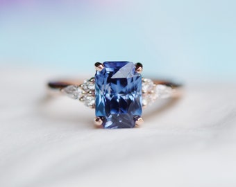 Radiant Blue Sapphire Ring in 14k gold with diamond clusters. Emerald Radiant cut Sapphire ring. Campari by Eidelprecious