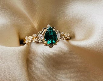 Arwen elvish fairytale pear cut emerald and diamonds engagement ring in gold. Unique fantasy nature inspired engagement ring.