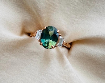 Parti Green Sapphire Engagement Ring. Vibrant bi-color green sapphire and baguette diamonds ring. Oval gold engagement ring by Eidelprecious