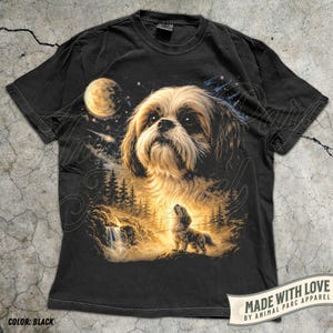 May include: Black t-shirt featuring a detailed illustration of a Shih Tzu dog under a starry night sky with a full moon. The design includes a waterfall and forest scene. The text "MADE WITH LOVE" is visible.