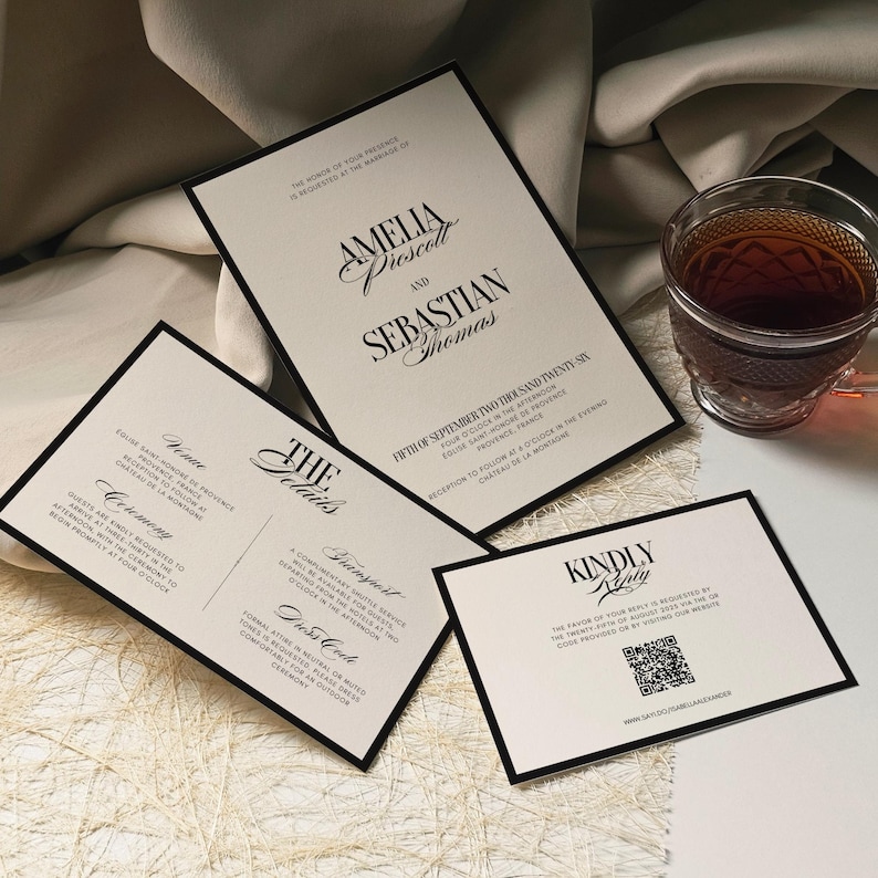 May include: Elegant wedding invitation suite with black borders and cream-colored paper. The main invitation features the names Amelia Prescott and Sebastian Thomas. Additional cards detail ceremony and reception information.
