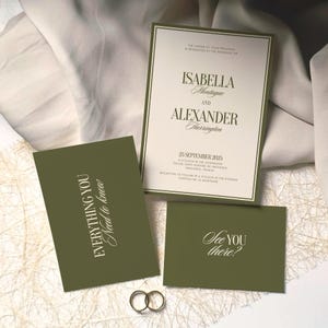 May include: A wedding invitation suite featuring a cream-colored main card with dark green borders and text, alongside two olive green cards with white lettering reading "EVERYTHING YOU Need to know" and "See YOU there?" with two gold rings.