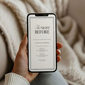 May include: A smartphone displaying a formal invitation with the text "The Night Before." The invitation is for Caroline & Theodore, with event details in black text on a white background, framed by a black border. The phone is held against a soft, neutral-toned backdrop.