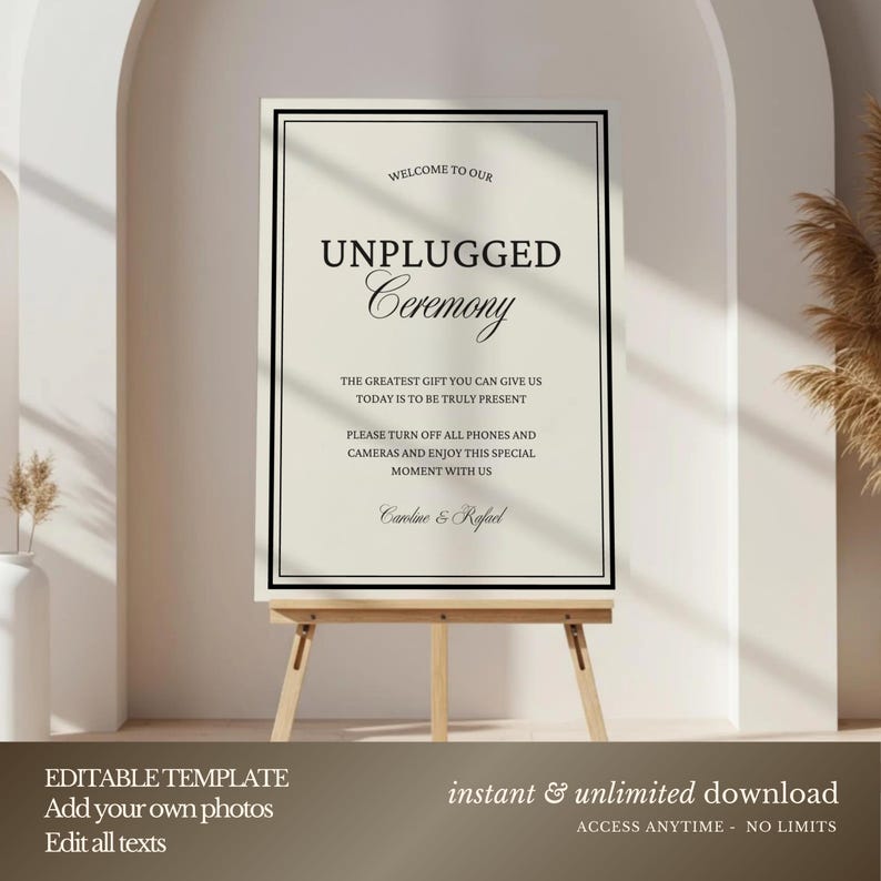 May include: A cream-colored sign with black text on a wooden easel. The sign reads "Welcome to our Unplugged Ceremony" and includes a message about turning off phones and cameras. The bottom of the sign says "Caroline & Rafael".