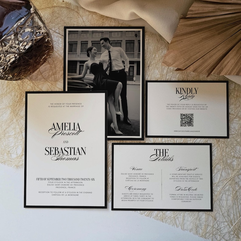 May include: A collection of wedding stationery featuring a black and white photograph of a couple, along with invitation cards. The invitations have black borders and include text such as names, dates, and event details.