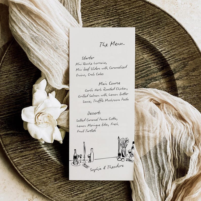May include: A menu card with handwritten text, featuring a list of dishes for a meal. The card is white with black text and illustrations, placed on a textured, gold-toned plate with a cream-colored cloth and a white flower.