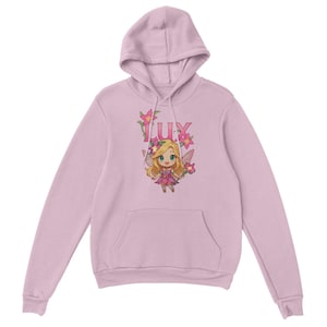 May include: A pale pink hoodie with a cartoon fairy design and the word "LUX". The fairy has blonde hair, a flower crown, and pink wings. The design is on the front of the hoodie, which also has a hood and a front pocket.