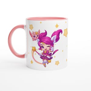 May include: White ceramic mug with a pink interior and handle. The mug features a cartoon illustration of a character with pink hair, a wand, and a small winged creature. Yellow stars are scattered around the design.