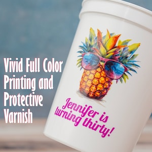 Image highlighting a personalized plastic stadium cup with a vibrant pineapple design and text 'Jennifer is turning thirty! ; Features bold text: 'Vivid Full Color Printing and Protective Varnish.' Ideal for custom birthday party favors.