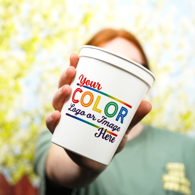 May include: White disposable cup with the text "Your Color Logo or Image Here" in rainbow colours.