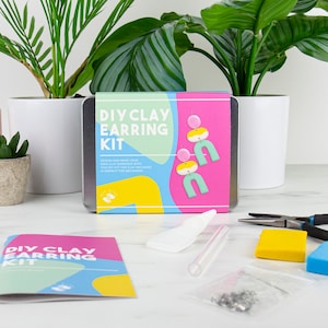 May include: A DIY clay earring kit with a colourful design. The kit includes tools and materials to make earrings. The text on the box reads "DIY Clay Earring Kit".