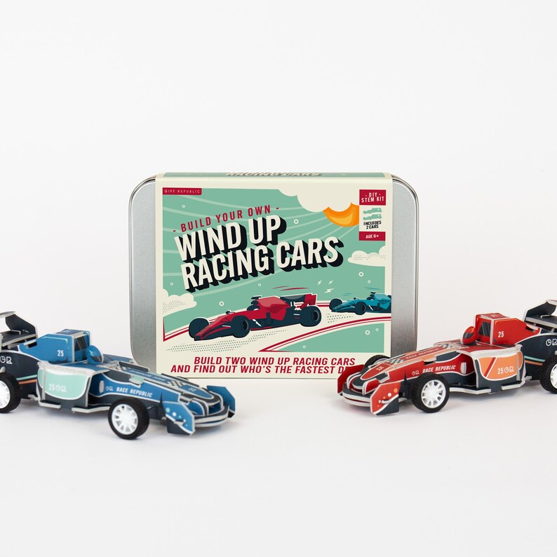 May include: A DIY STEM kit for building wind-up racing cars. The kit includes a metal tin with the text "Build Your Own Wind Up Racing Cars" and two assembled race cars in red and blue. The cars have the number 25 on them.