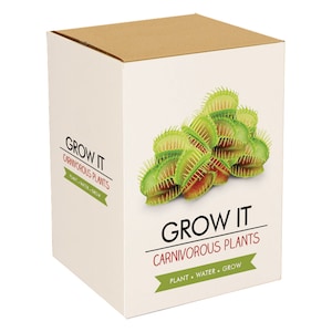 May include: A white box with a brown lid, labelled "GROW IT CARNIVOROUS PLANTS." The box shows a collection of green Venus flytraps with red insides. The text "PLANT • WATER • GROW" is also visible.