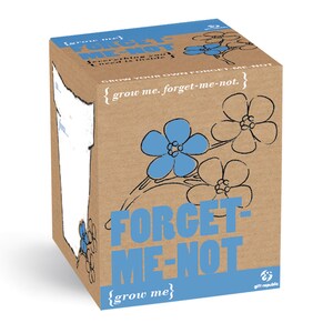 May include: A brown cardboard box with a blue forget-me-not flower design. The box has the text "Grow me. Forget-me-not. Everything you need is inside." and "Grow your own forget-me-not. {grow me. forget-me-not.} Forget-me-not. {grow me} gift republic".