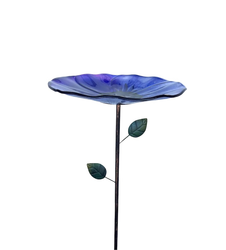 A blue bird bath with two green leaves attached to it, standing alone against a white background.