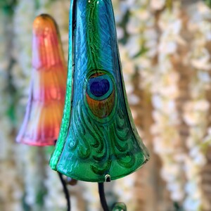 a close-up of a colorful, ornate lamp with a peacock feather design.