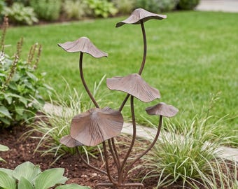 May include: A metal garden sculpture featuring five mushroom-shaped caps on thin, curved stems. The sculpture has a weathered, brownish-bronze finish with visible radial lines on the underside of each cap, creating a textured, organic appearance.