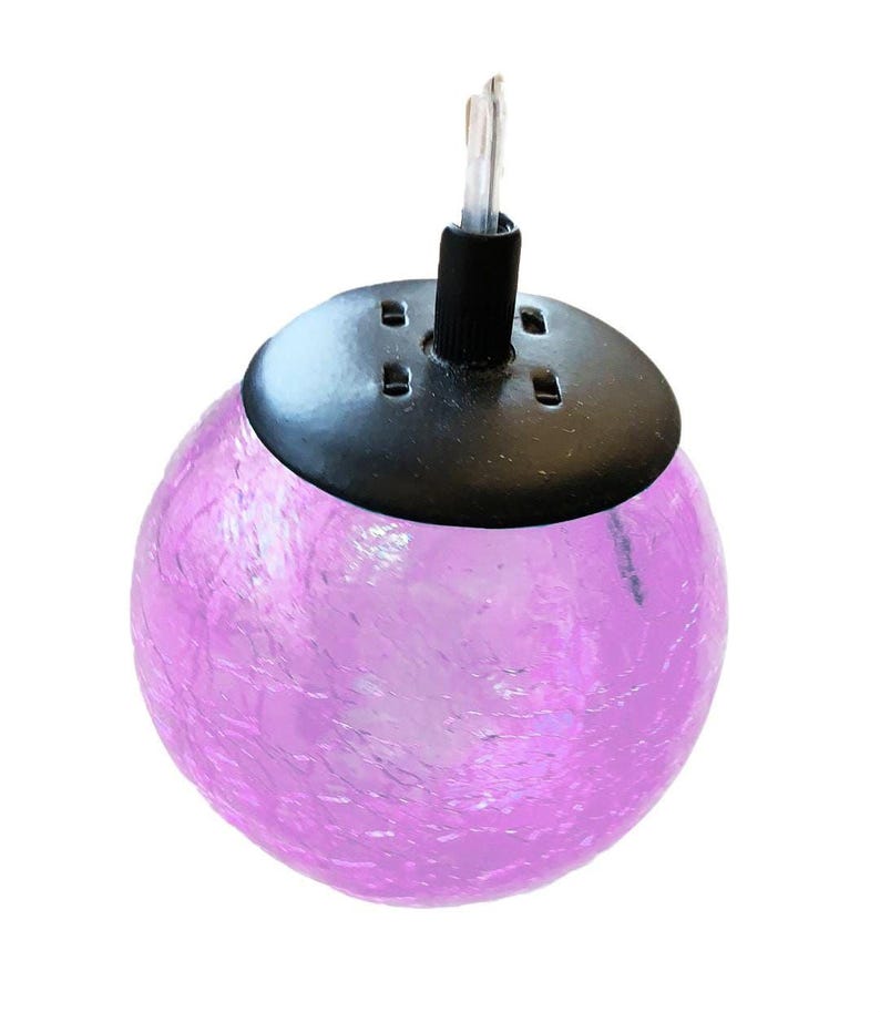 A purple glass globe with a black base and a black cord attached to it.