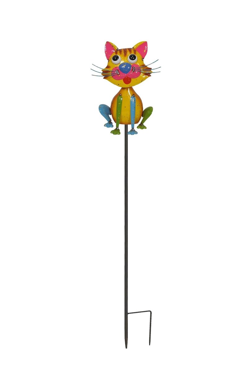 A colorful metal cat figurine sitting on a stick.