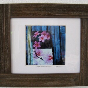 May include: A framed print of a collage featuring pink flowers and blue bamboo. The title of the artwork is "Centered - Single Branch".