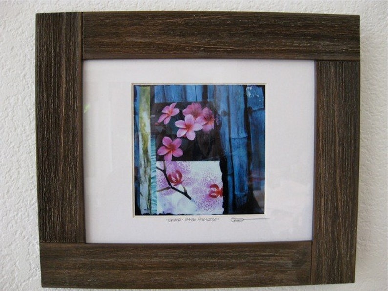 May include: A framed print of a collage featuring pink flowers and blue bamboo. The title of the artwork is "Centered - Single Branch".