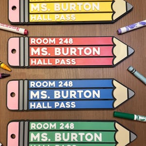 May include: Four pencil-shaped hall pass signs with the text "ROOM 248 MS. BURTON HALL PASS" in white lettering. The signs are yellow, red, blue, and green.
