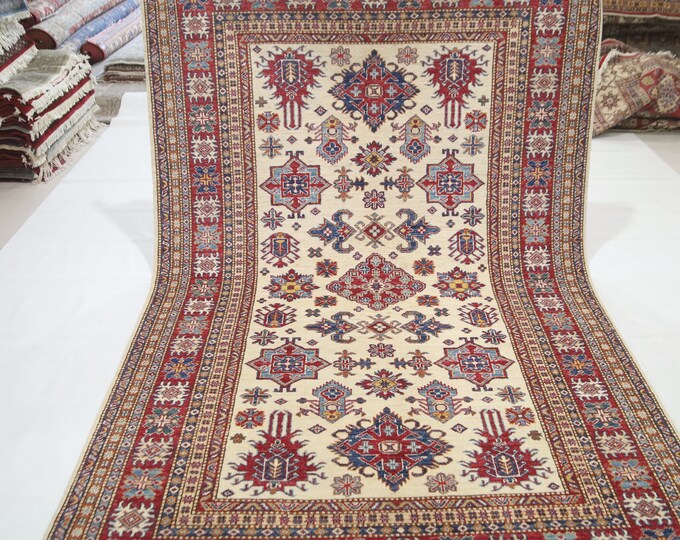 Handmade Afghan Kazak Wool Rug (5'4x8'3) – Beige and Red Geometric Area Rug