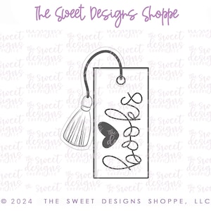 May include: A gray and white bookmark with a tassel and the word "books" written in a decorative script. The bookmark has a heart shape at the top.