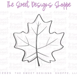 May include: A leaf-shaped cookie cutter with a gray outline and interior details. The text "The Sweet Designs Shoppe" is at the top. The copyright and company name are at the bottom.