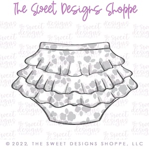 May include: A black and white line drawing of a ruffled skirt with a floral pattern. The skirt has three ruffles and is designed for a baby or toddler.