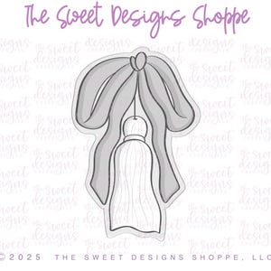 May include: A gray and white tassel with a gray bow. The tassel is hanging from a string. The image is on a white background with the text "The Sweet Designs Shoppe" and "C2025 THE SWEET DESIGNS SHOPPE, LLC".