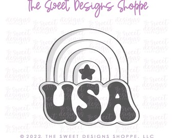 May include: A cookie cutter in the shape of a rainbow with a star and the word "USA" in a retro font.