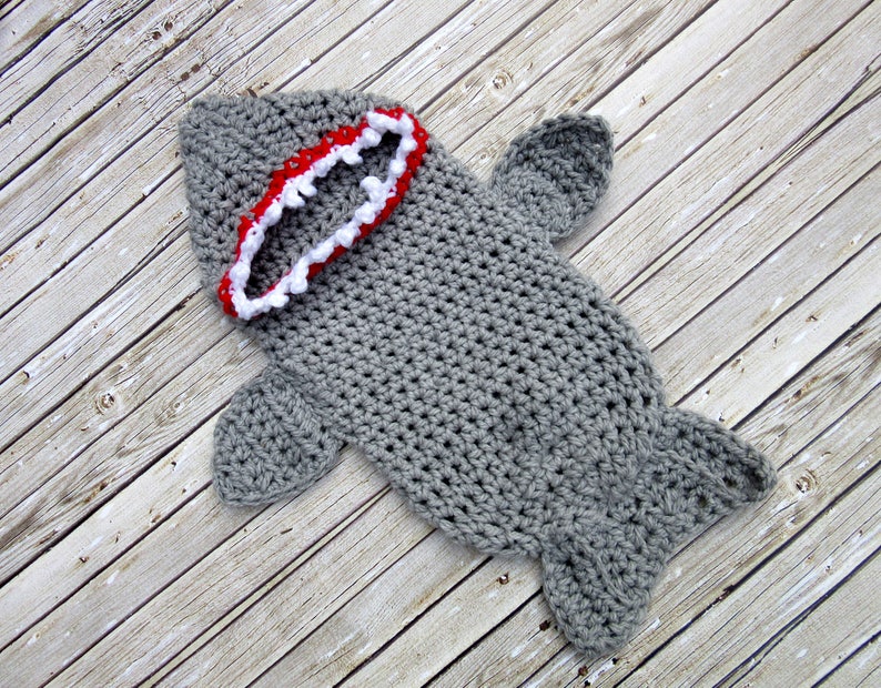 May include: Grey crocheted shark costume with a red and white open mouth.